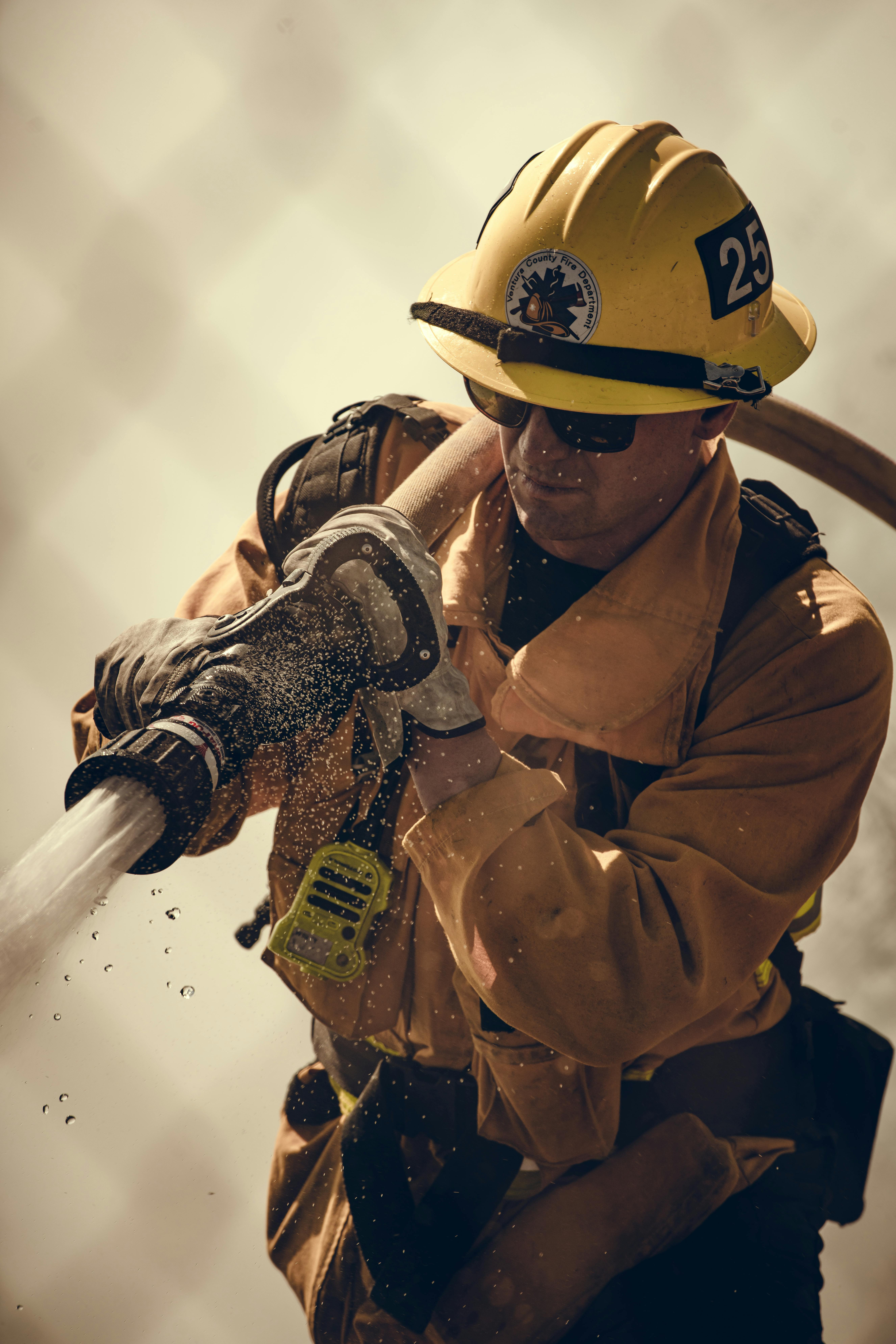 firepennyfire fighter carrying hose wearing ppe gear