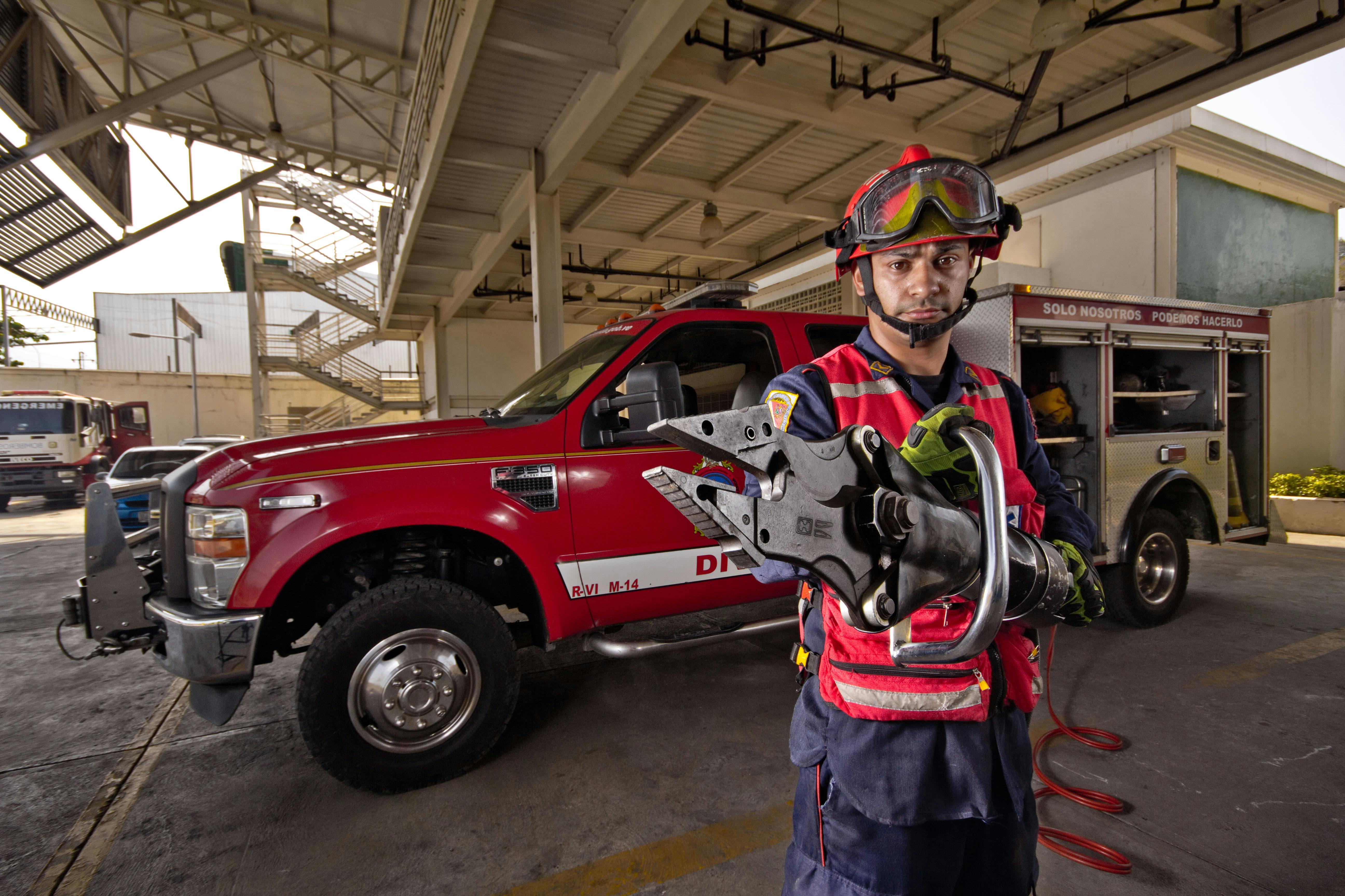 firefighter holding hydraulic rescue tool